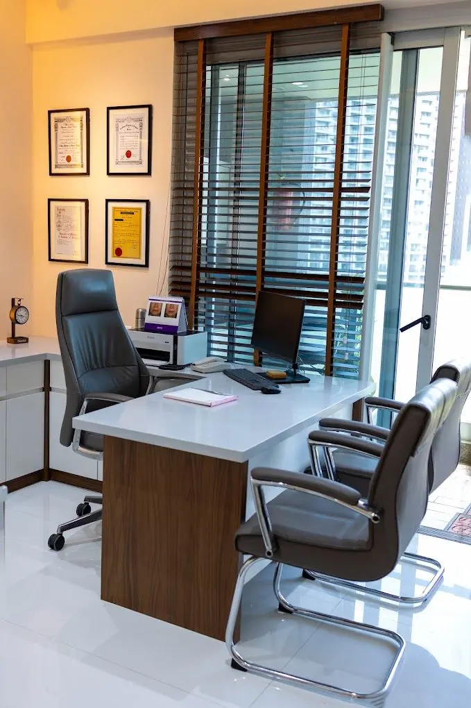 Consulting room desk with framed qualifications